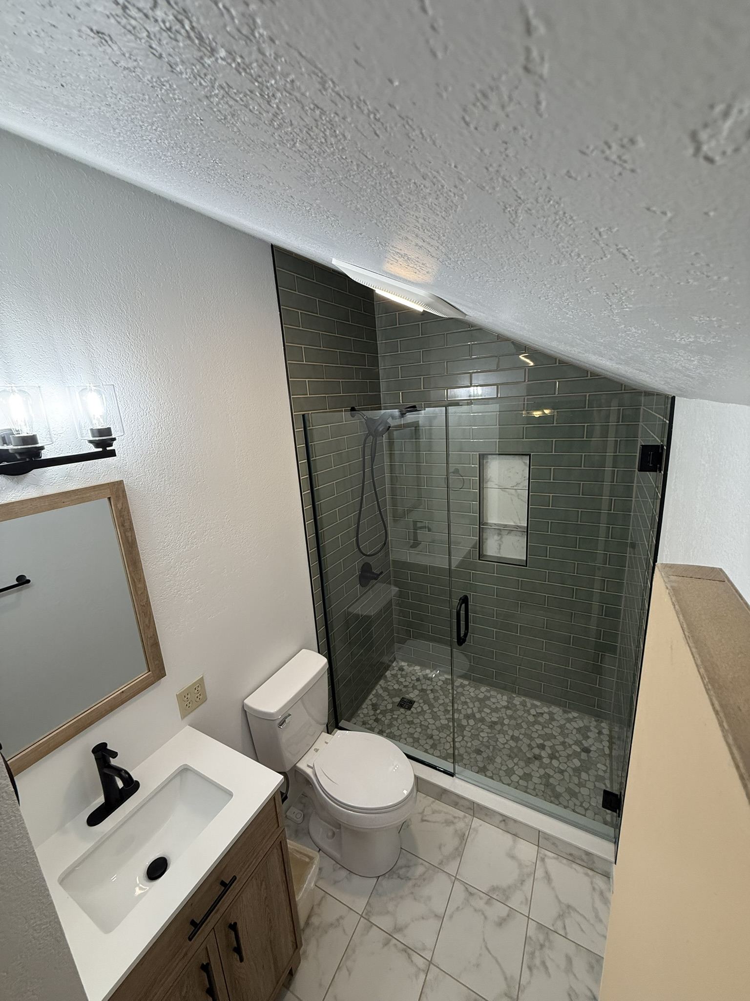 Bathroom remodel with tile shower and vanity